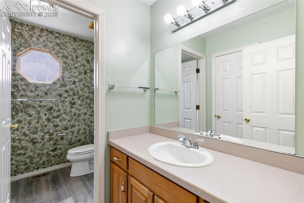 Image 22 of 50: Main Level Full Bathroom with linen closet
