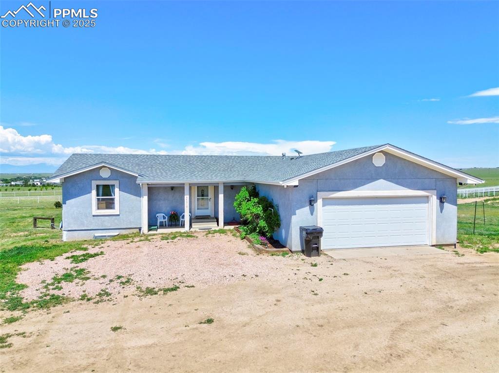 Image 5 of 50: Covered Porch faces East- Total Square Feet 3310 with an oversized garage!