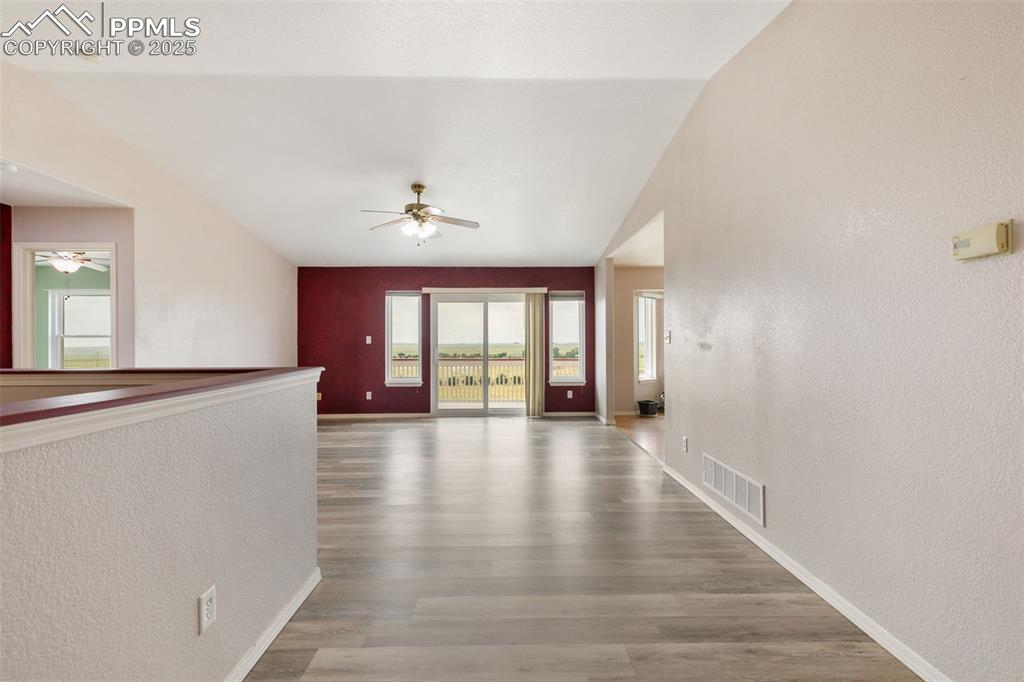 Image 7 of 50: New LVP Flooring in Living Room - High Ceilings- Walks out to Deck with Wes