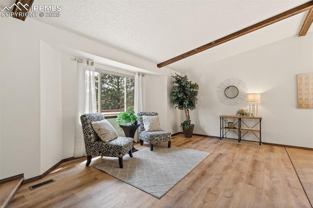 Image 10 of 32: Bay window, beamed ceiling, new flooring, new paint