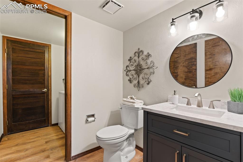 Image 21 of 32: 1/2 bathroom off the family room, adjoining laundry room with washer and dr
