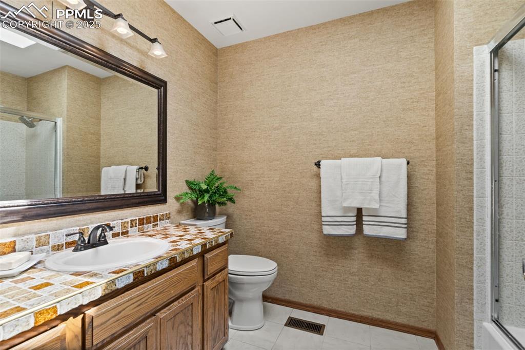 Image 24 of 32: Upper full bathroom with skylight