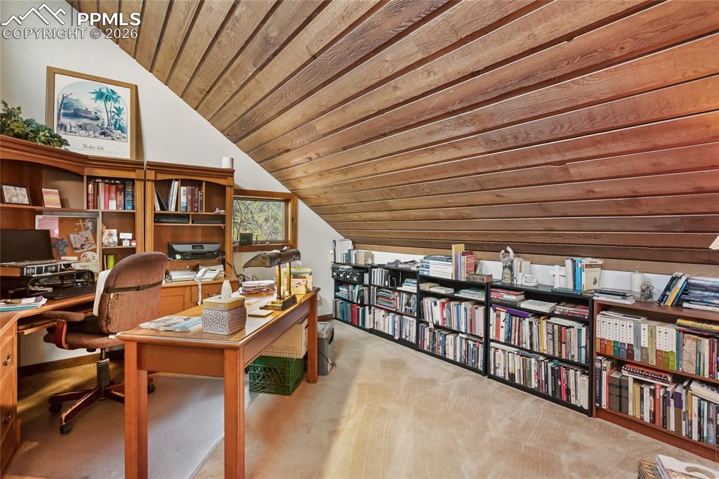 Image 16 of 39: Carpeted office featuring wooden lofted ceiling!