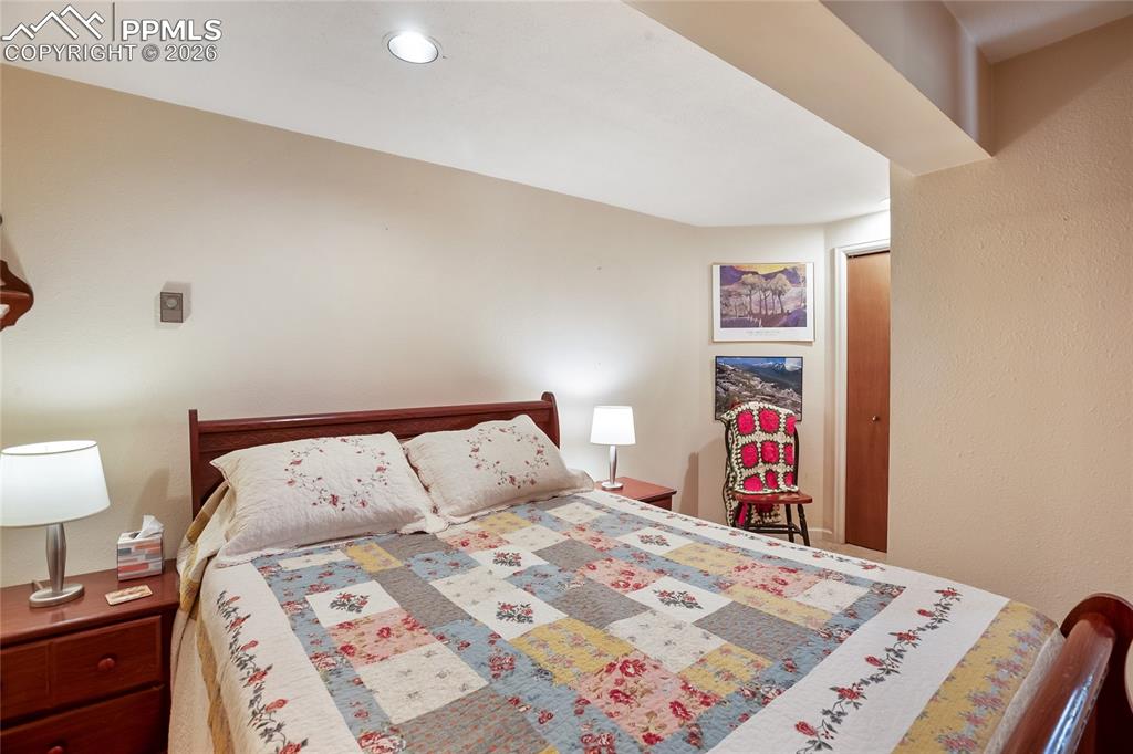 Image 23 of 39: Bedroom with carpet and recessed can lighting