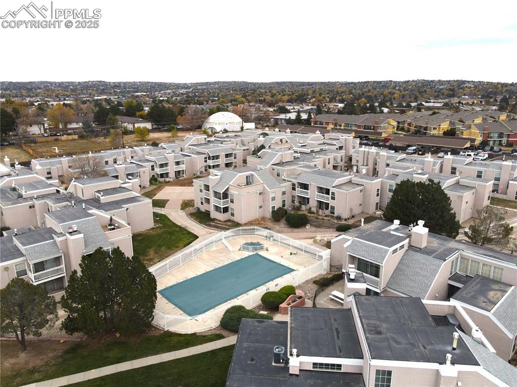 Image 25 of 27: Aerial perspective of suburban area featuring a pool area