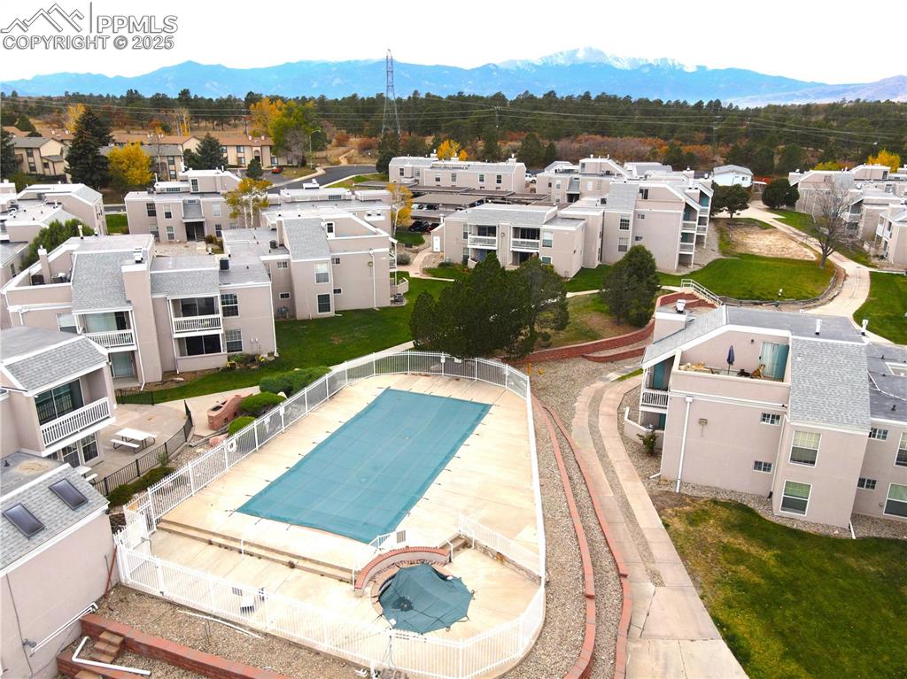 Image 26 of 27: Aerial perspective of suburban area featuring a mountainous background
