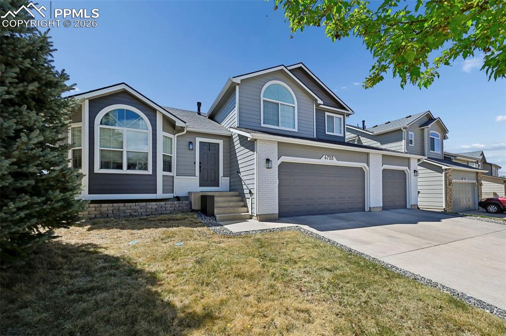 Image 2 of 45: The property features a multi-car garage, a concrete driveway, and an exter