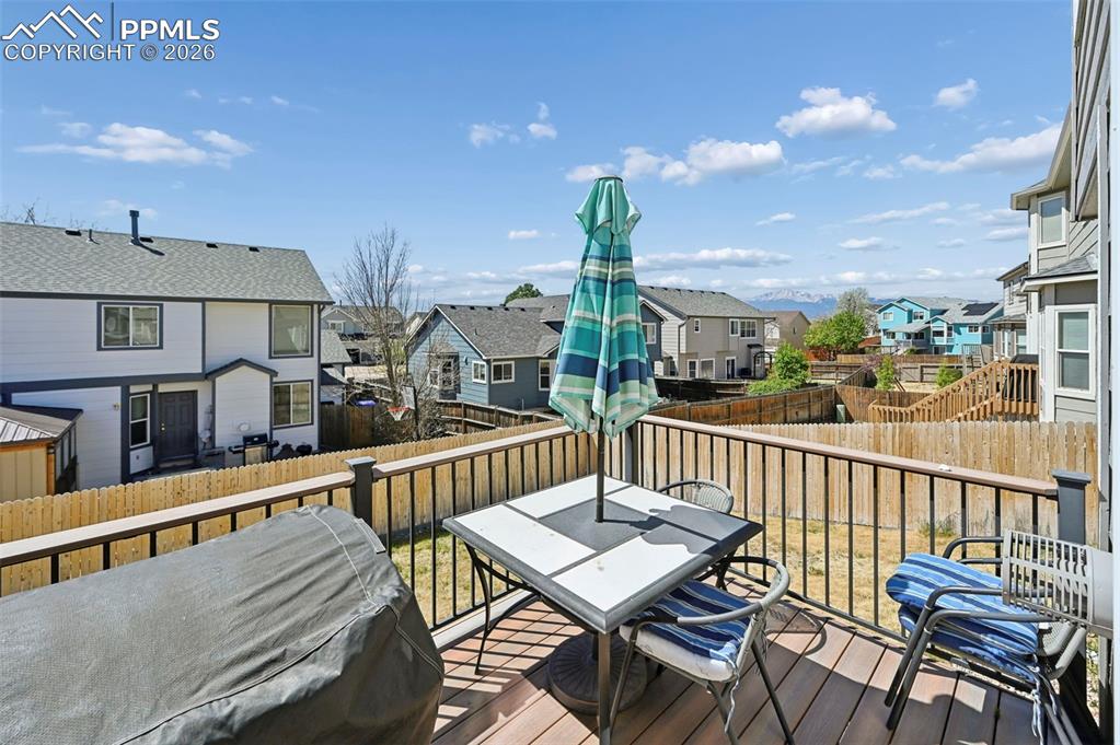 Image 28 of 45: The property features a spacious deck with dark railings and a wooden floor