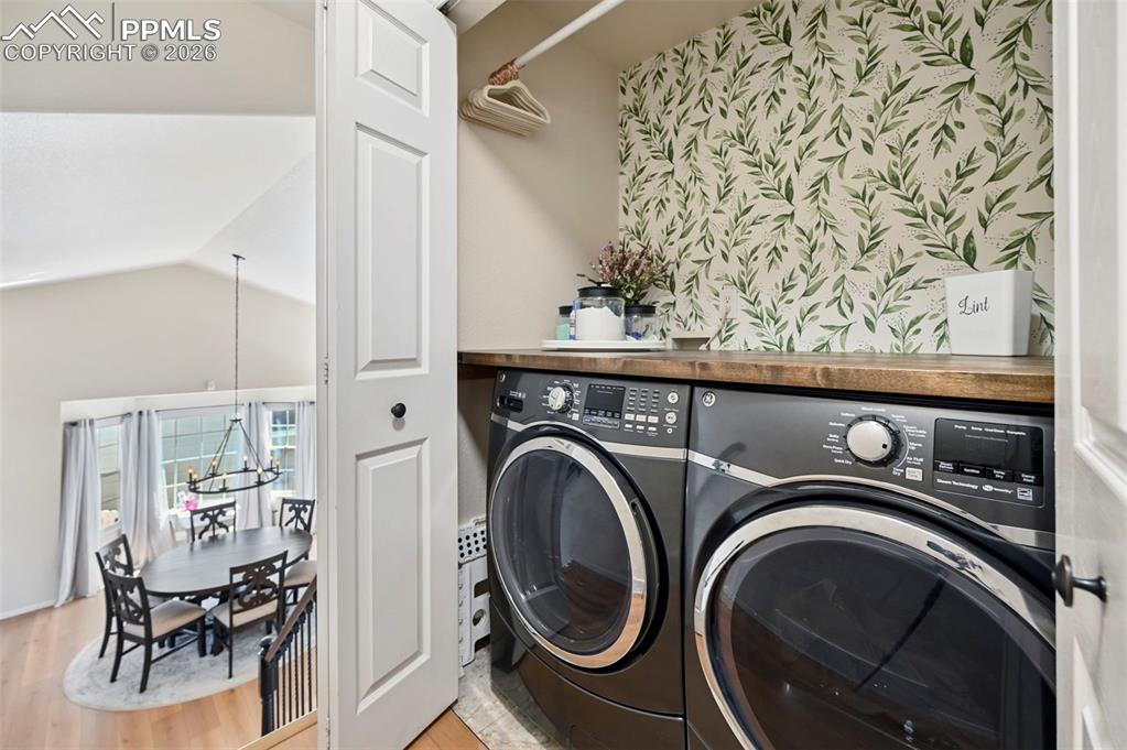 Image 30 of 45: Dedicated laundry area featuring a wooden countertop and a decorative botan
