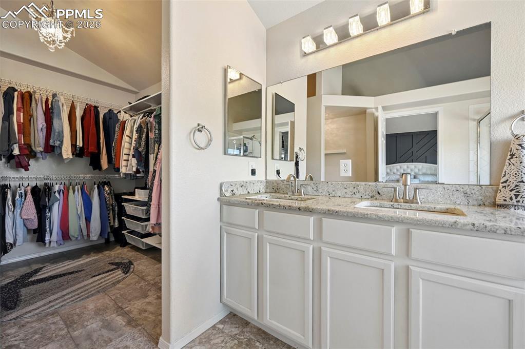 Image 41 of 45: Well-appointed vanity featuring a spacious countertop, dual sinks with chro