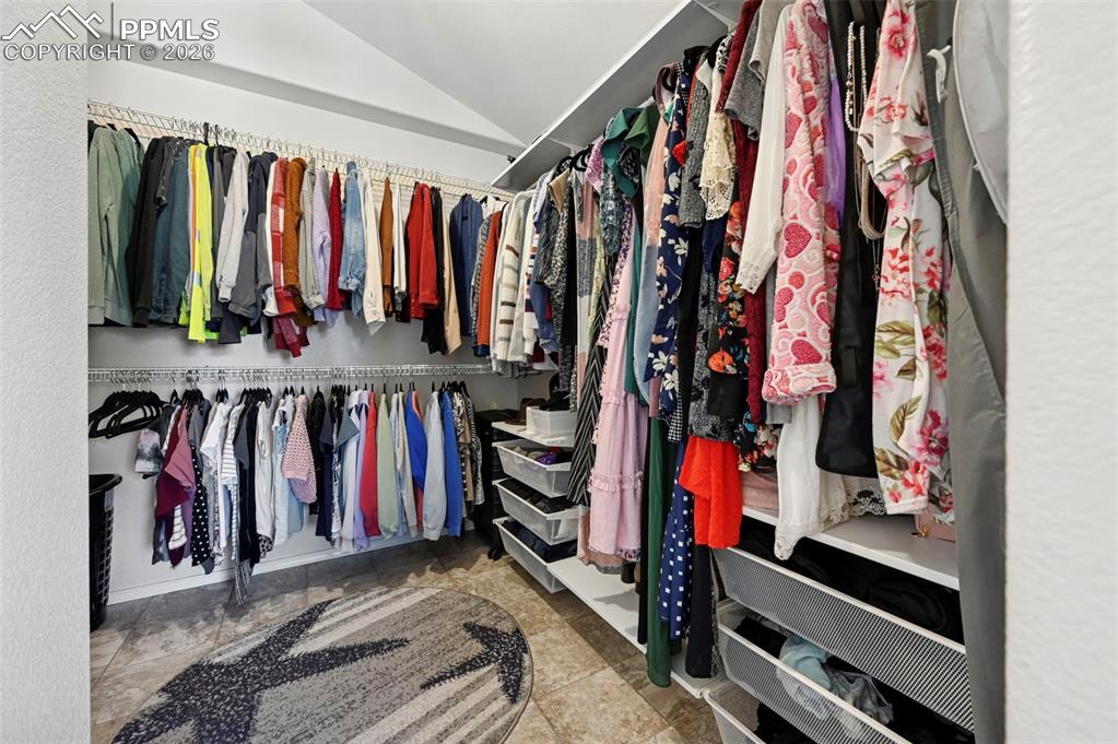 Image 42 of 45: The property features a spacious walk-in closet with extensive storage, inc
