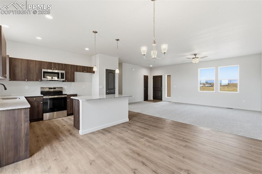 Image 11 of 24: Kitchen featuring a chandelier, decorative light fixtures, stainless steel 