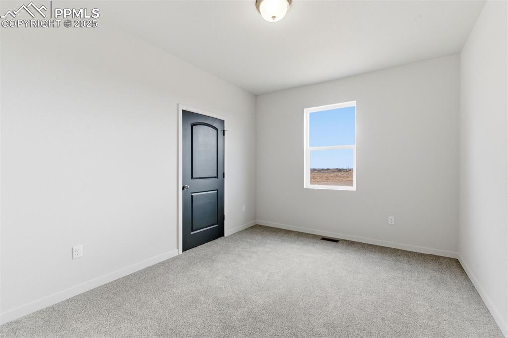 Image 13 of 24: Carpeted spare room with baseboards