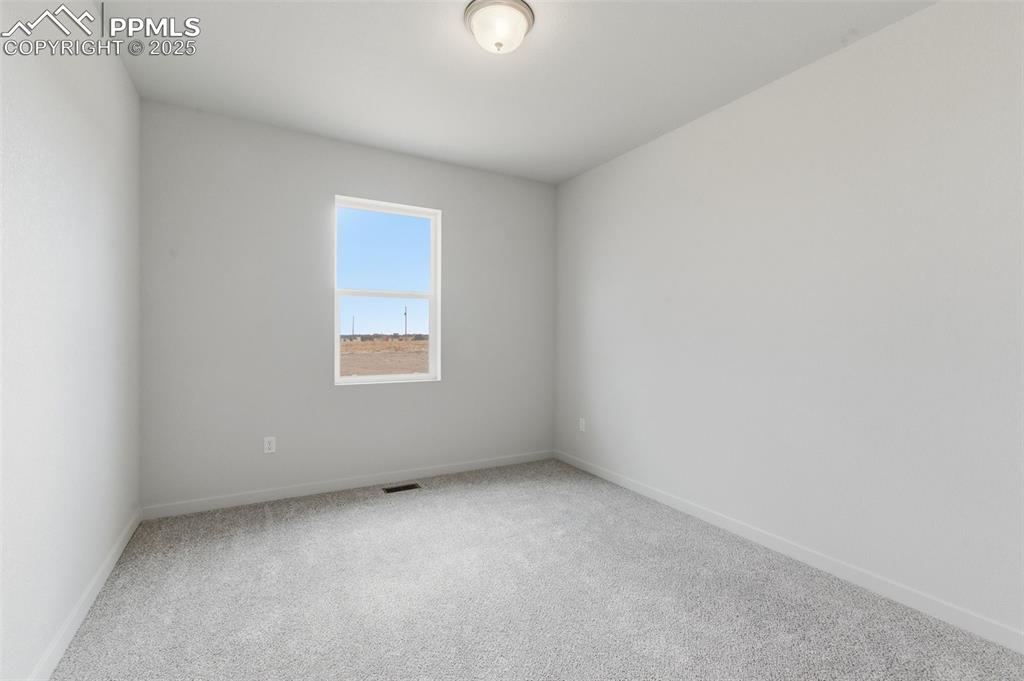 Image 15 of 24: Carpeted spare room with baseboards