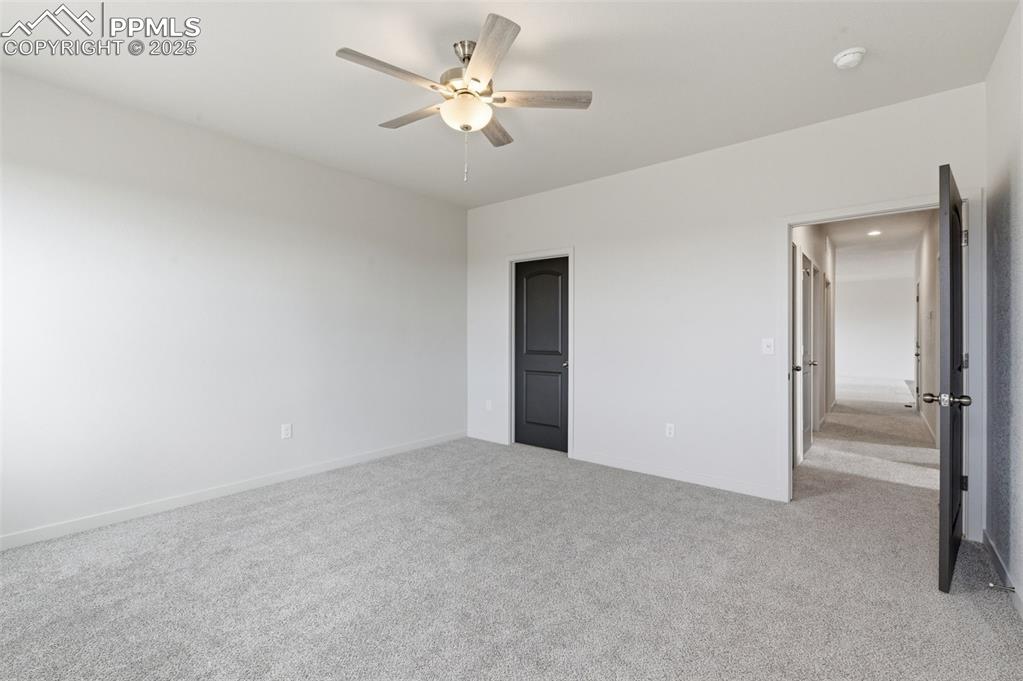 Image 20 of 24: Unfurnished bedroom featuring light carpet and a ceiling fan