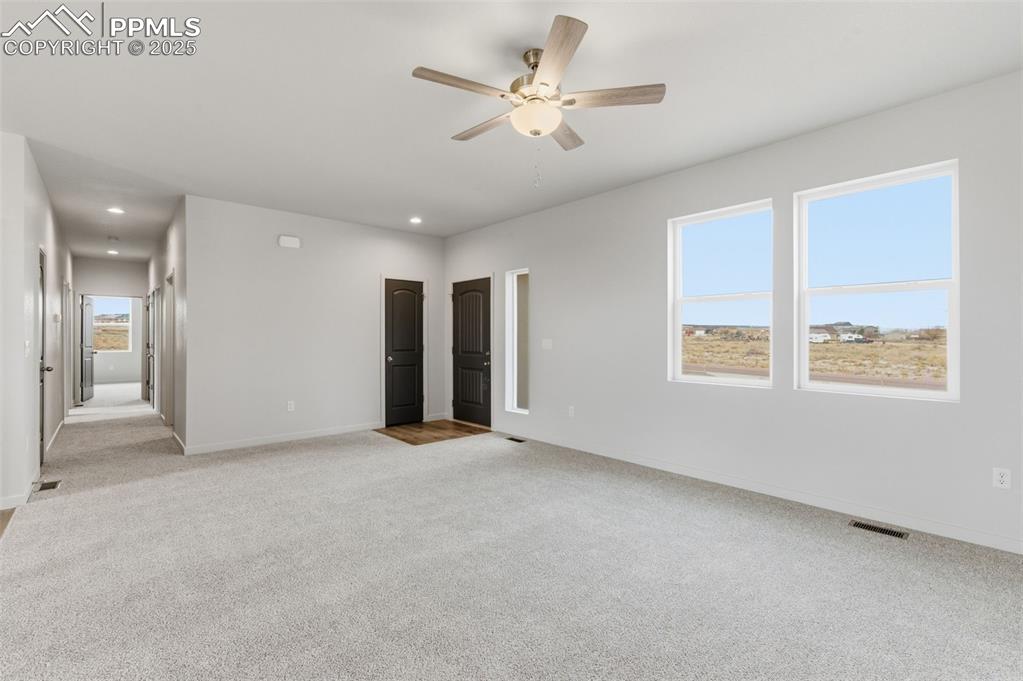 Image 4 of 24: Unfurnished bedroom featuring light carpet, ceiling fan, and recessed light