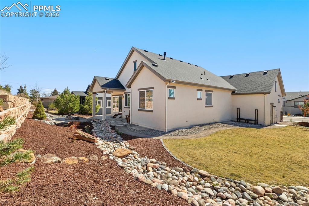 Image 2 of 44: Private backyard w/ fire pit and large grass area