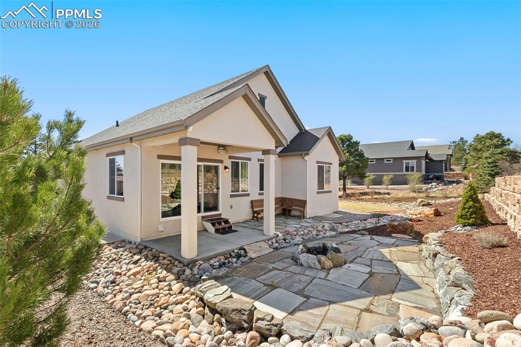 Image 38 of 44: Private backyard w/ fire pit and large grass area