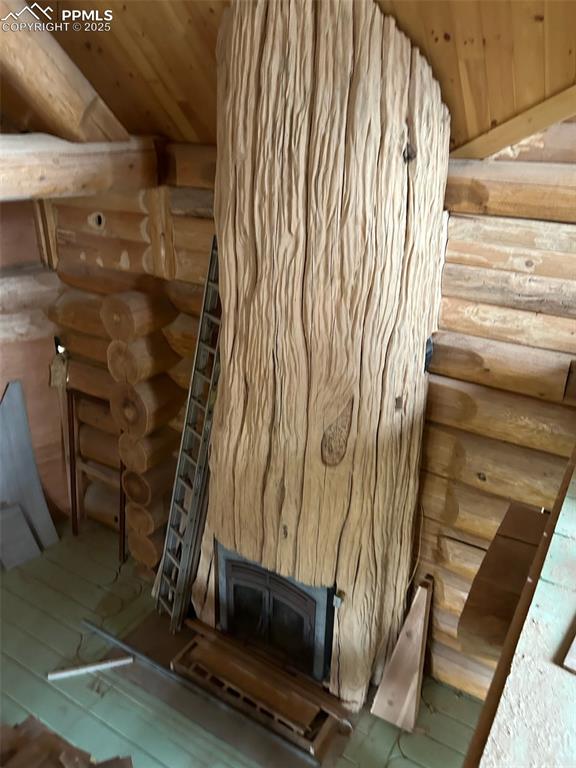 Image 13 of 17: Not the actual property -- Detailed view of rustic Post, a wood stove, and 