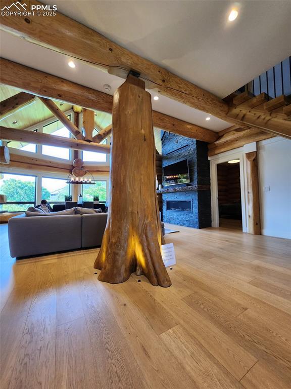 Image 15 of 17: Not the actual property -- Living area with a fireplace, hardwood / wood-st