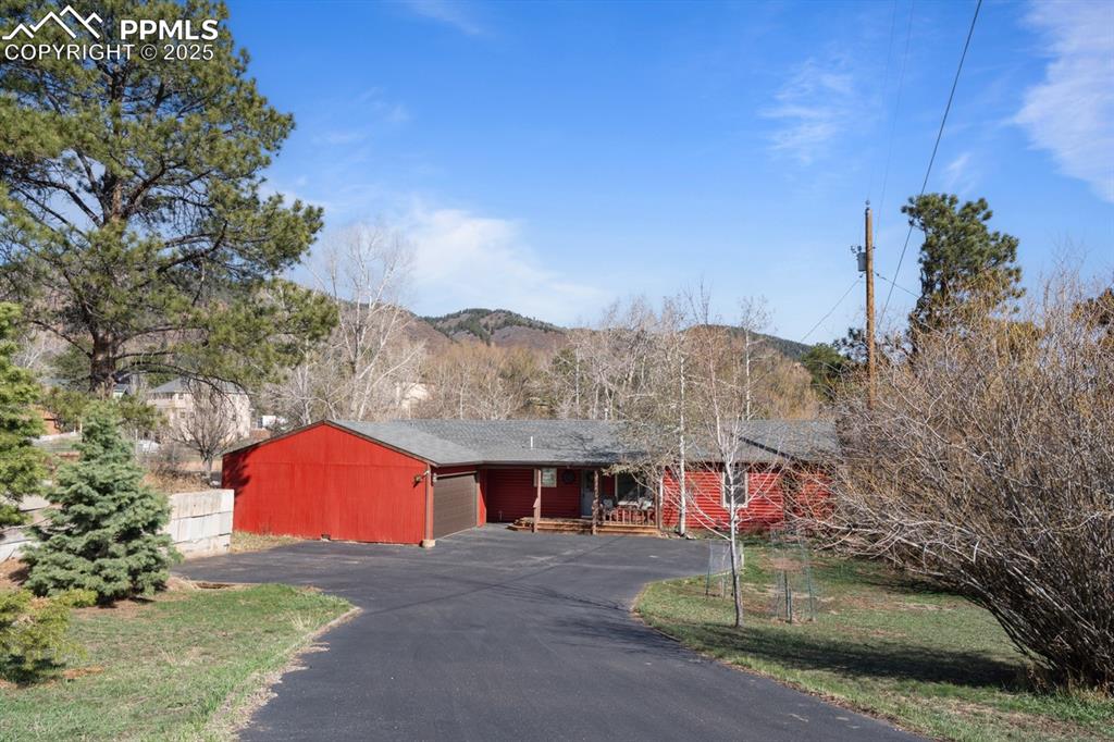 Image 25 of 36: Detached 2-car garage is oversized, has electric and is connected by a bree