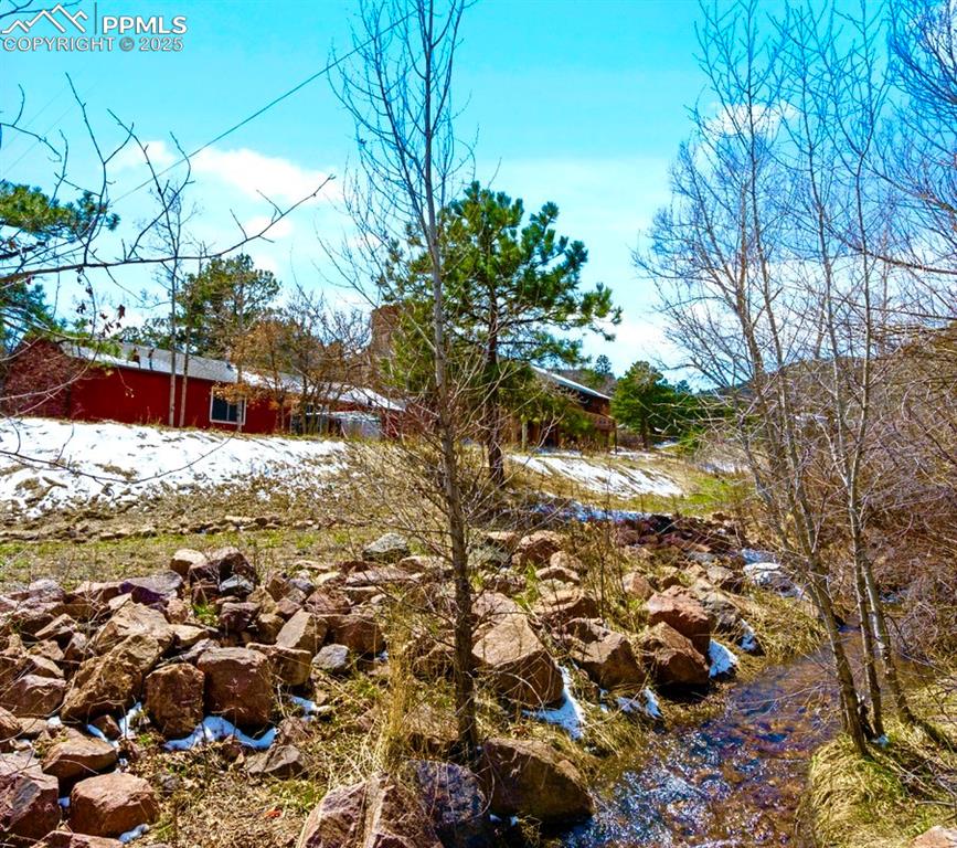 Image 32 of 36: Active creek is a few footsteps from the property line. 