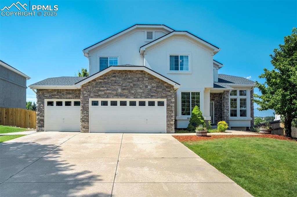 Caption: Beautiful stucco & stone exterior with a quarter acre lot. 