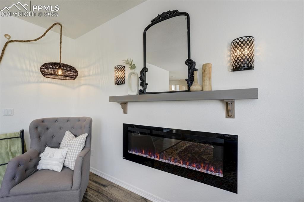 Image 15 of 50: Fireplace & mantel ready for the holidays. 