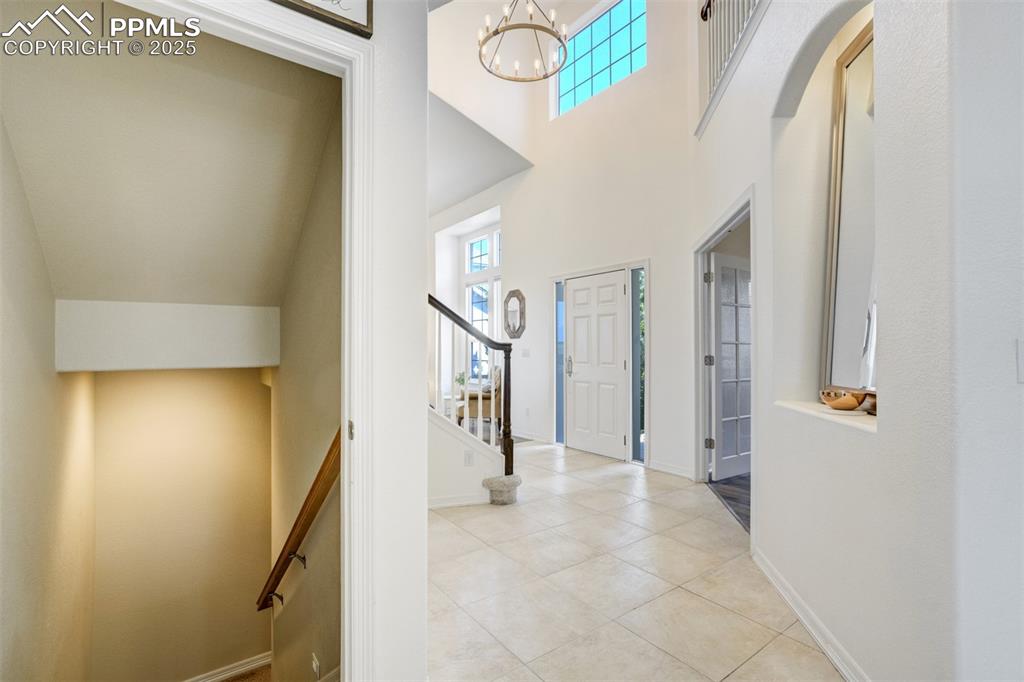 Image 17 of 50: Another look at the entryway. Staircase down leads to the finished walk-out