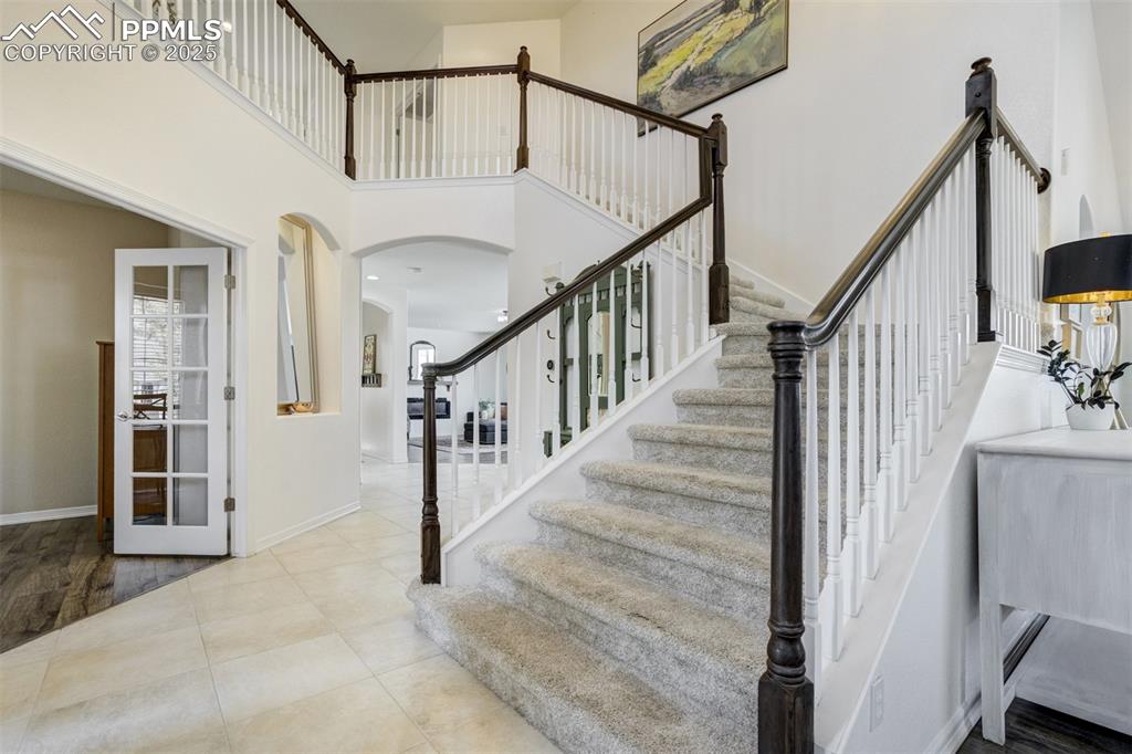 Image 18 of 50: Grand entrance with a lovely staircase. 
