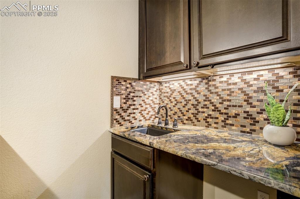 Image 36 of 50: wet bar kitchenette in the basement. 