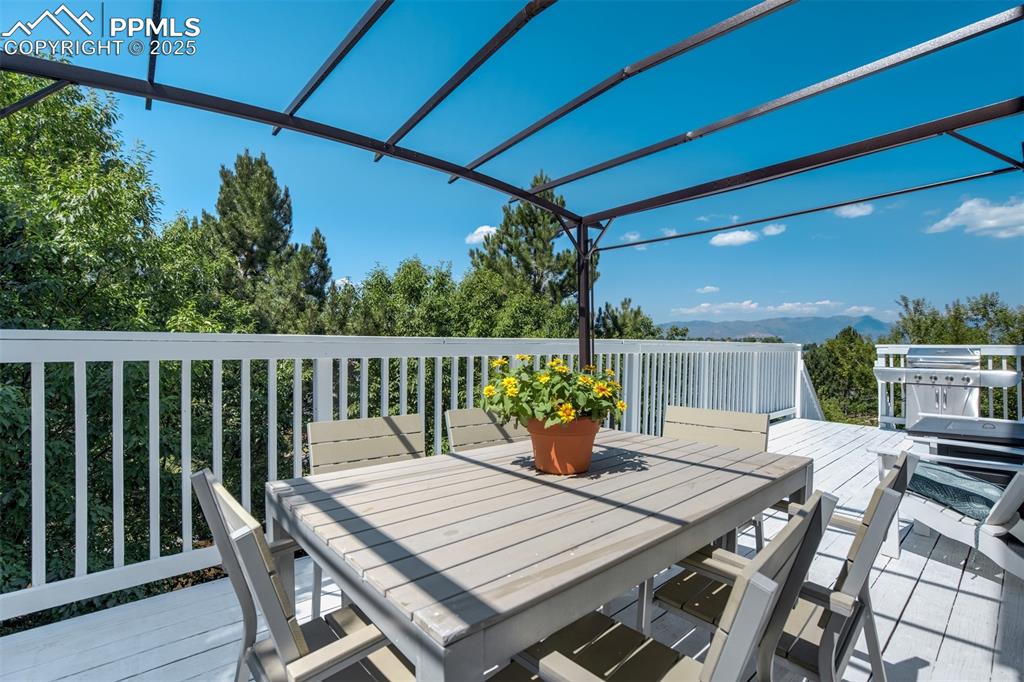 Image 43 of 50: Large deck off the main level with mountain views. 
