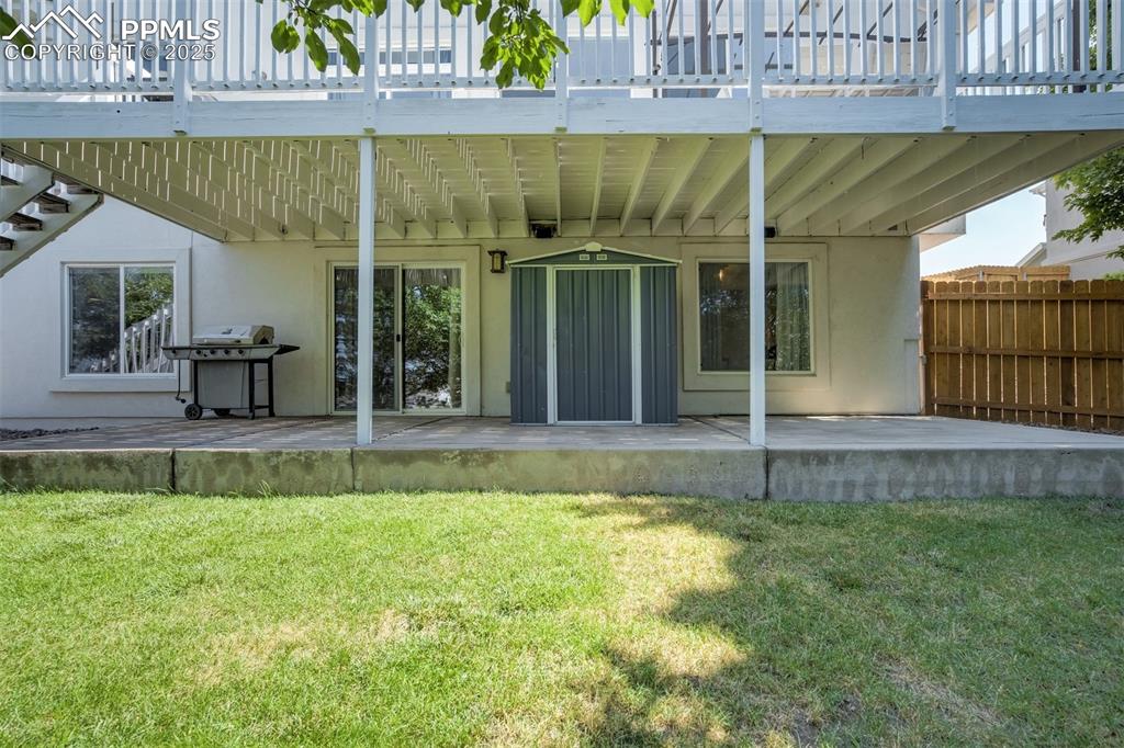 Image 46 of 50: Concrete pathway from the driveway leads to direct access to the basement &