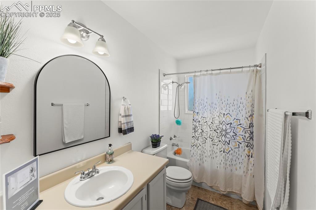 Image 16 of 25: Bathroom featuring shower / bath combo and vanity