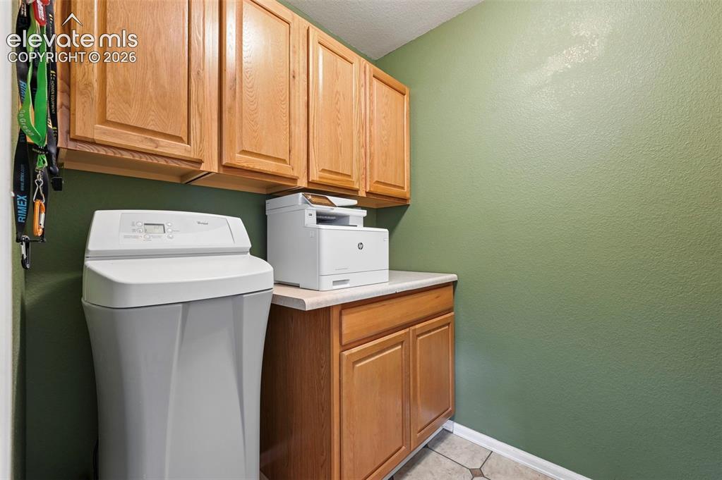 Image 14 of 49: Main level storage room with water softener