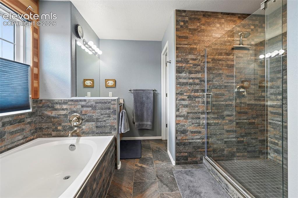 Image 19 of 49: Soaking tub, stand alone tile shower, double vanities 