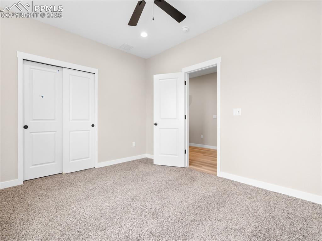 Image 18 of 38: Unfurnished bedroom with light colored carpet, a closet, recessed lighting,
