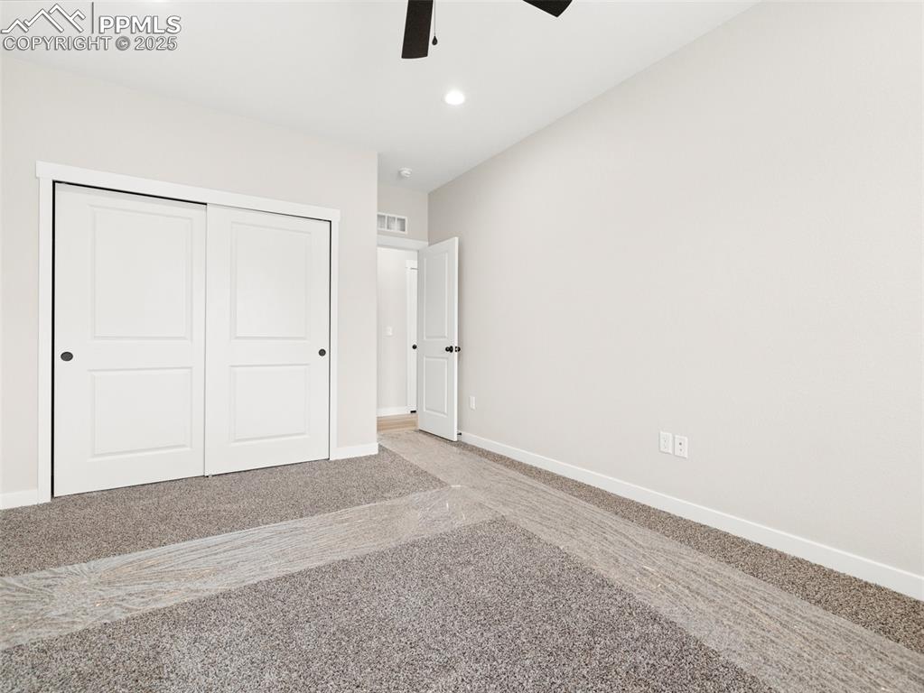 Image 20 of 38: Unfurnished bedroom featuring a closet, recessed lighting, carpet floors, a
