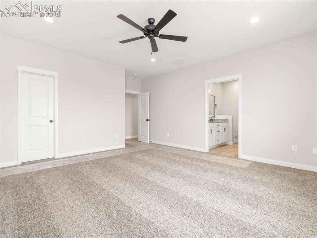 Image 25 of 38: Unfurnished bedroom featuring recessed lighting, light carpet, connected ba