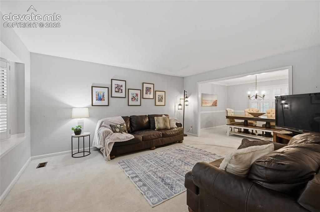 Image 11 of 49: Formal Living Room main level looking into formal dining room