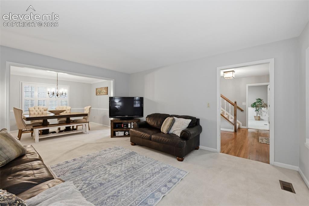 Image 12 of 49: Formal living room looking towards front of home