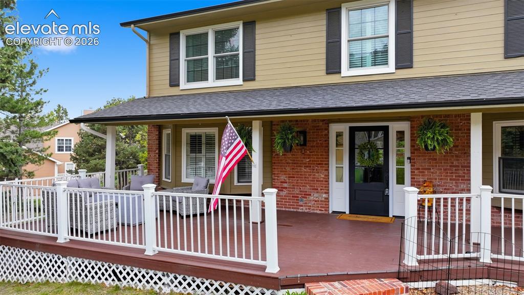 Image 2 of 49: front entry deck large enough for entertaining