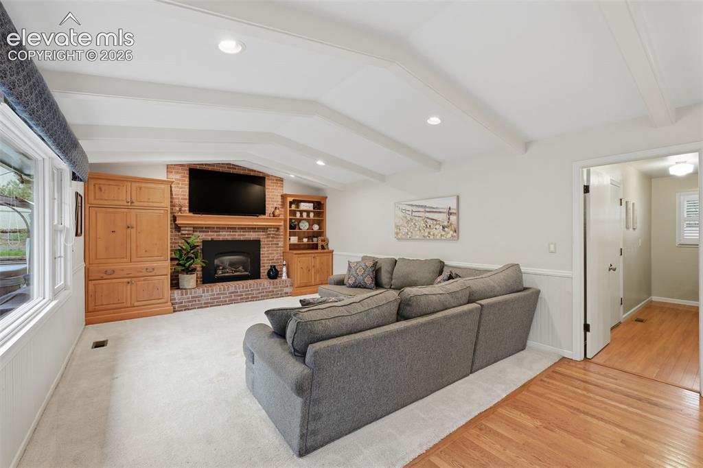 Image 20 of 49: Family room with fireplace and built ins
