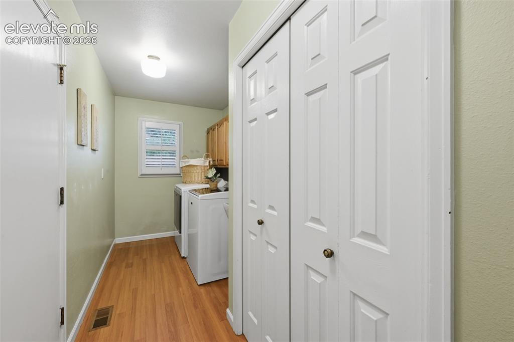 Image 21 of 49: Laundry room with door to garage and window
