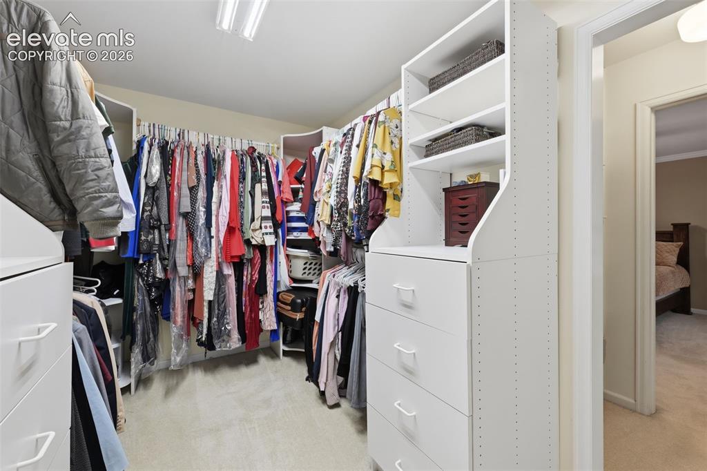 Image 25 of 49: Primary bedroom walk in closet