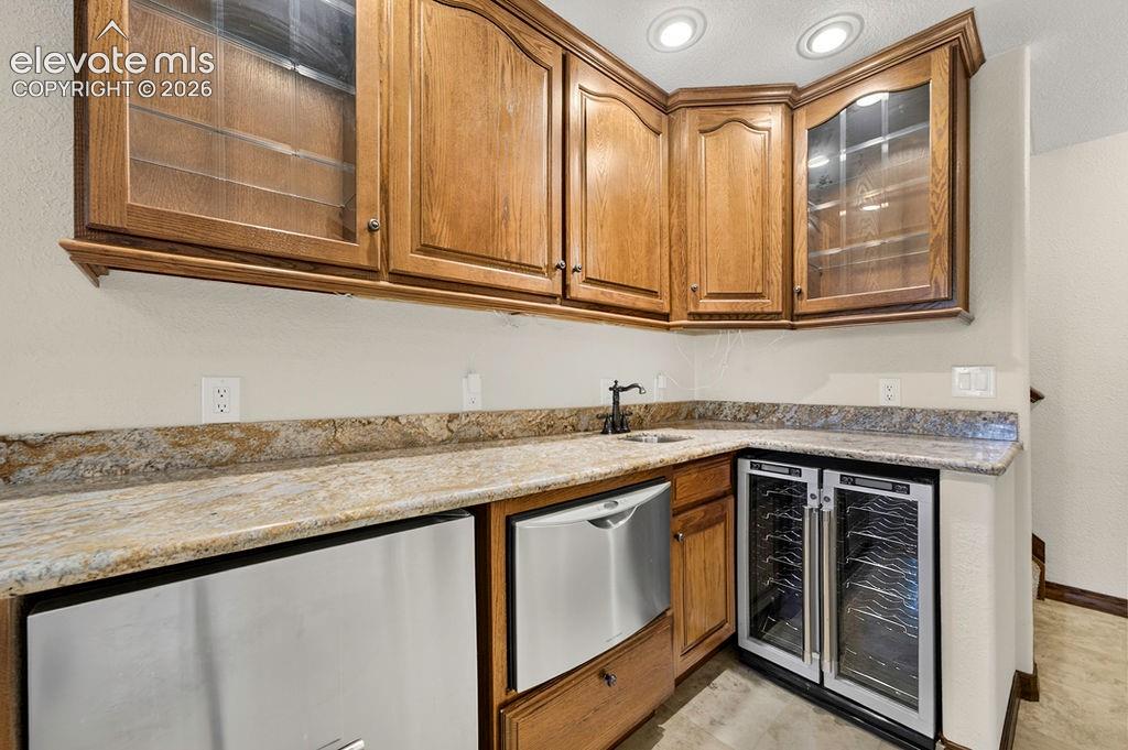Image 44 of 50: Basement Wet bar- has dishwasher drawer, disposal sink, and beverage fridge