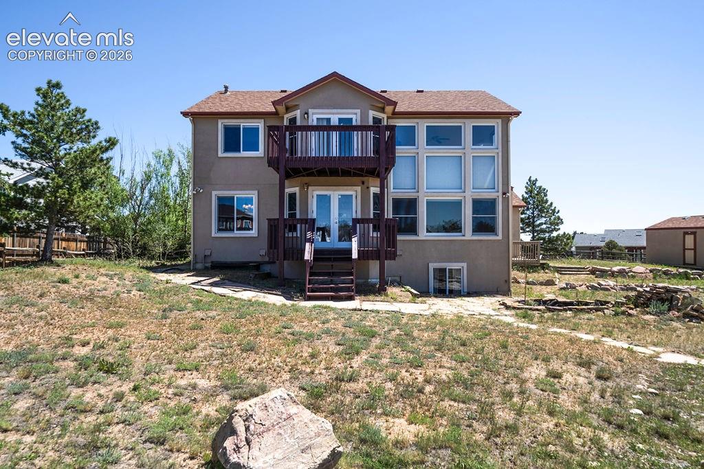 Image 7 of 50: Back of home. Upper deck off Loft area!