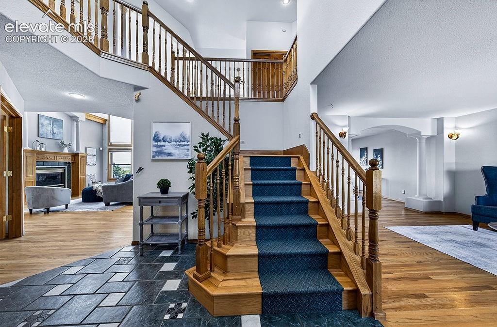 Image 9 of 50: Sweeping stairs opening to the foyer!