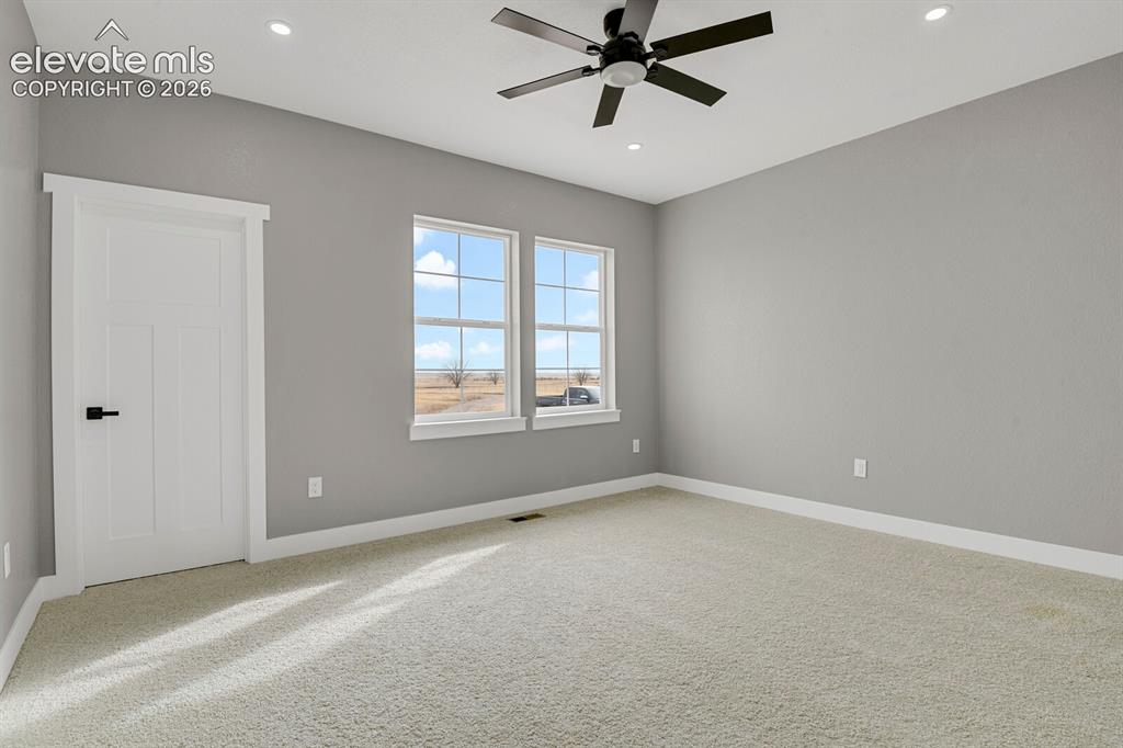 Image 26 of 49: Recessed ceiling lighting, ceiling fan, carpeted flooring, and two paneled