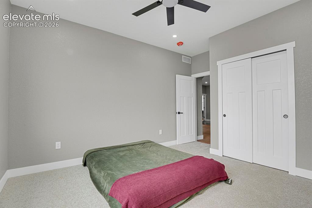 Image 27 of 49: Light-colored carpeted flooring, white trim, recessed ceiling lighting, cei